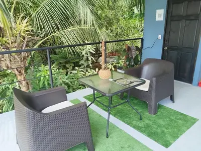 a patio with two chairs and a table and a table at Osaglamping in Palmar Norte