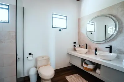 a bathroom with two sinks and a mirror at Casa Dalia in Monteverde Costa Rica