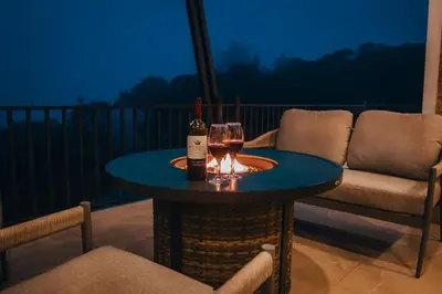 a table with a bottle of wine and a glass at Casa Dalia in Monteverde Costa Rica