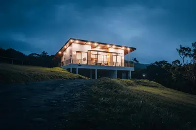 a house on a hill with lights on it at Casa Dalia in Monteverde Costa Rica