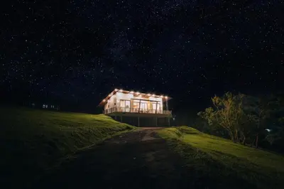 a house on top of a hill at night at Casa Dalia in Monteverde Costa Rica