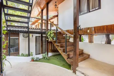 a wooden staircase in a house with windows at La Buena vida Cabina 2 in Refundores