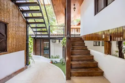 a hallway with wooden stairs in a house at La Buena vida Cabina 2 in Refundores