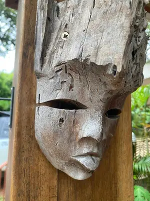 a mask is attached to a wooden pole at Tekana Boutique Jungle Retreat in Tamarindo