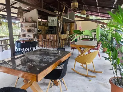 a table and chairs in a room with plants at Tekana Boutique Jungle Retreat in Tamarindo