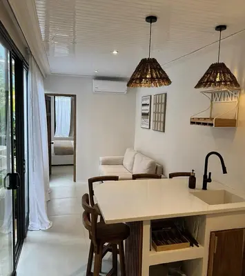 a kitchen and living room with a table and chairs at Calalun in Fortuna