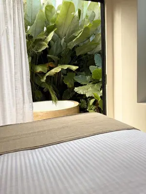 a bedroom with a window with a plant at Calalun in Fortuna