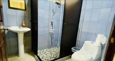 a bathroom with a shower with a toilet and a sink at Mountain Retreat in Bijagua de Upala with Stunning Nature Views in Bijagua