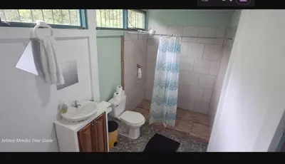 a bathroom with a sink and a toilet and a shower at Mountain Retreat in Bijagua de Upala with Stunning Nature Views in Bijagua