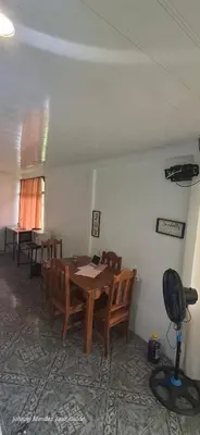 a dining room with a wooden table and chairs at Mountain Retreat in Bijagua de Upala with Stunning Nature Views in Bijagua