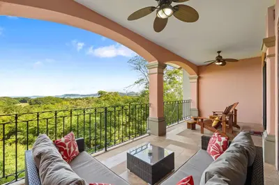 a living room with a couch and a balcony at Treetop Ocean View Penthouse - Jobo 15 in Playa Conchal