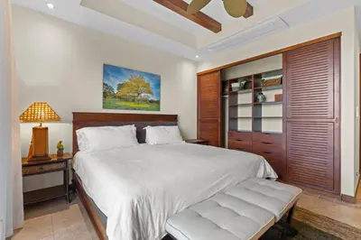 a bedroom with a large white bed and a bench at Treetop Ocean View Penthouse - Jobo 15 in Playa Conchal