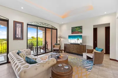 a living room with a couch and a tv at Treetop Ocean View Penthouse - Jobo 15 in Playa Conchal