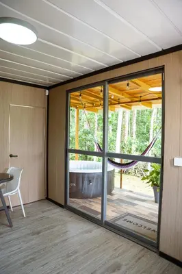 a room with a sliding glass door and a tub at Villa Azul-Colibrí, Río Celeste in Rio Celeste