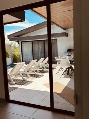 a view of a patio with chairs and a table at Casa Celeste in Uvita