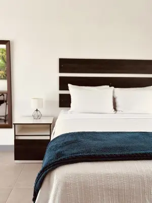 a bedroom with a large bed with a blue blanket at Casa Celeste in Uvita