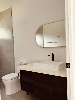 a bathroom with a sink and a toilet and a mirror at Casa Celeste in Uvita