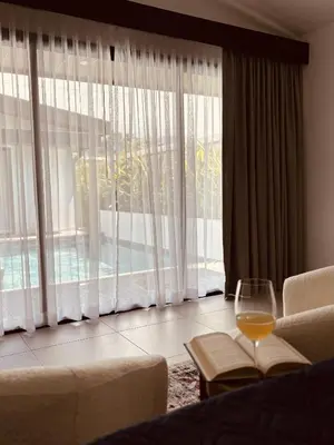 a living room with a glass of wine in front of a window at Casa Celeste in Uvita