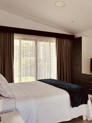 a bedroom with a large bed and a large window at Casa Celeste in Uvita