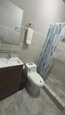 a bathroom with a toilet and a sink and a shower at Central and comfortable mini apartment in San Sebastian in San José