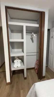 a bedroom with a closet with white shelves at Central and comfortable mini apartment in San Sebastian in San José