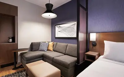 a living room with a couch and a bed at Hyatt Place Cariari/Convention Center in San José
