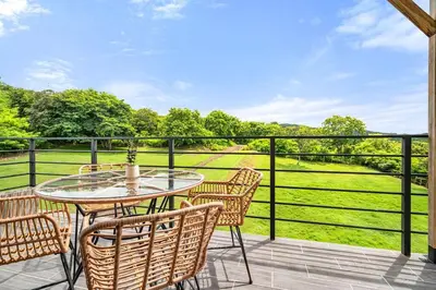 a patio with a table and chairs on a balcony at TH5 Peaceful Surf Retreat Walk to Beach and Town in Tamarindo
