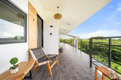 a room with a balcony with a bench at TH5 Peaceful Surf Retreat Walk to Beach and Town in Tamarindo