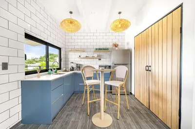a kitchen with a table and two stools at TH5 Peaceful Surf Retreat Walk to Beach and Town in Tamarindo