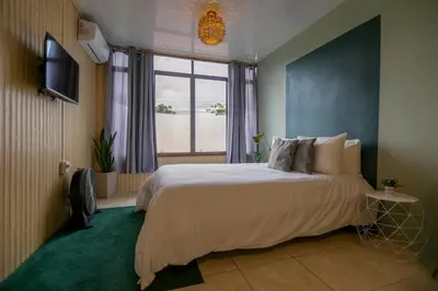 a bedroom with a large bed and a window at Lovely Loft with volcan view La Fortuna Downtown in Fortuna