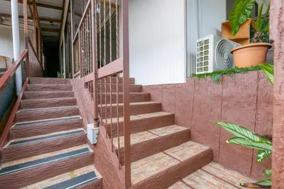 a set of stairs leading up to a house at Lovely Loft with volcan view La Fortuna Downtown in Fortuna