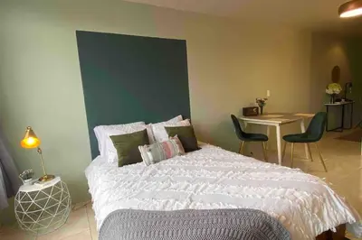 a bedroom with a bed and a table and chairs at Lovely Loft with volcan view La Fortuna Downtown in Fortuna