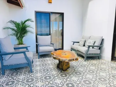 a living room with two chairs and a coffee table at Casa Colibri Tropical Ocean View 5 min to Beach in Nicoya