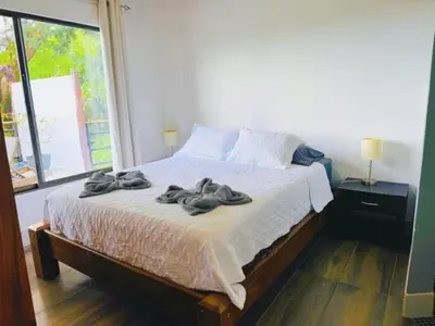 a bedroom with a bed with towels on it at Casa Colibri Tropical Ocean View 5 min to Beach in Nicoya