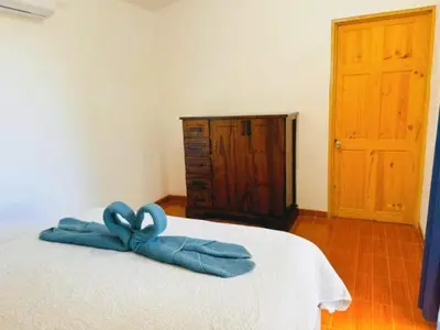 a bedroom with a bed with a blue bow on it at Casa Colibri Tropical Ocean View 5 min to Beach in Nicoya