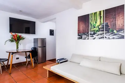 a living room with a white couch and a table at Hotel Gardenia Tamarindo in Tamarindo