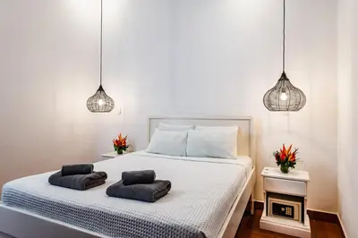 a bedroom with a bed with two pillows on it at Hotel Gardenia Tamarindo in Tamarindo