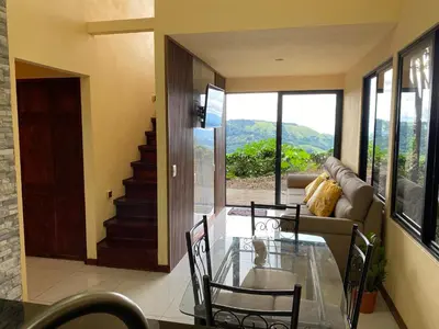 a living room with a glass table and a couch at Monteverde Beaumont in La Cruz