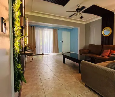 a living room with a couch and a table at Apartments for vacation by the Pasifc in Coco