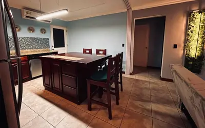 a kitchen with a island in the middle of a room at Apartments for vacation by the Pasifc in Coco