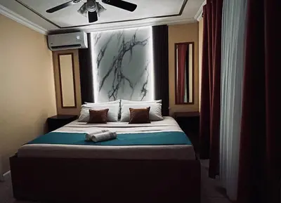 a bedroom with a bed with a ceiling fan at Apartments for vacation by the Pasifc in Coco
