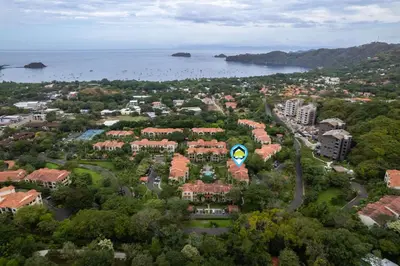 an aerial view of a city with houses and the water at Elegant Condo in High-End Resort Community with Pool and Beach Club Access in Coco
