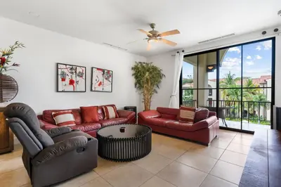 a living room with two couches and a ceiling fan at Elegant Condo in High-End Resort Community with Pool and Beach Club Access in Coco