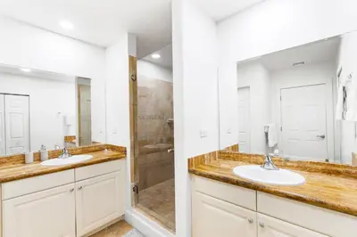 a bathroom with two sinks and a shower at Elegant Condo in High-End Resort Community with Pool and Beach Club Access in Coco