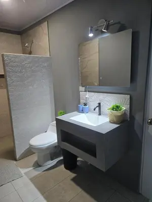 a bathroom with a sink and a toilet and a mirror at Uvita, Bahía Ballena, Ocean View in Uvita