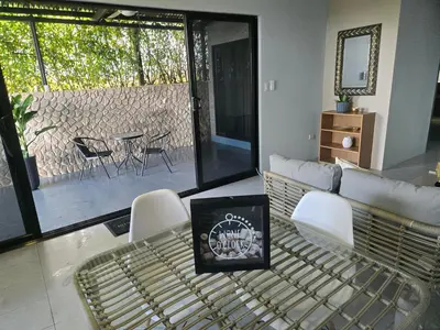 a living room with a couch and a table and chairs at Uvita, Bahía Ballena, Ocean View in Uvita