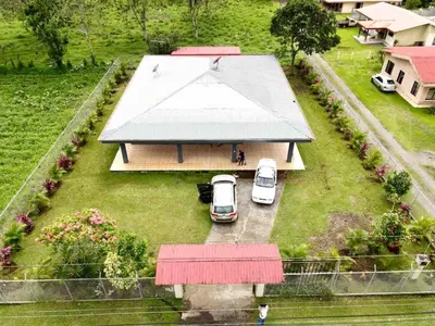 an aerial view of a house with cars parked in the yard at Gray Oasis, Private Pool in Agua Azul