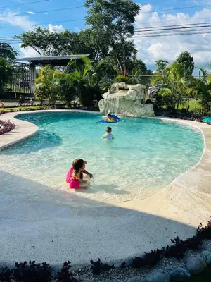 a little girl playing in a swimming pool at a resort at Gray Oasis, Private Pool in Agua Azul