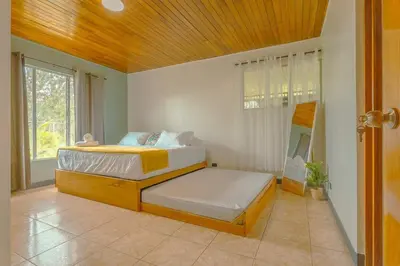 a bedroom with two beds and a wooden ceiling at Gray Oasis, Private Pool in Agua Azul