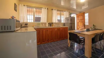 a kitchen with a wooden table and a counter top at Fortuna Flat Walk & Value in Fortuna